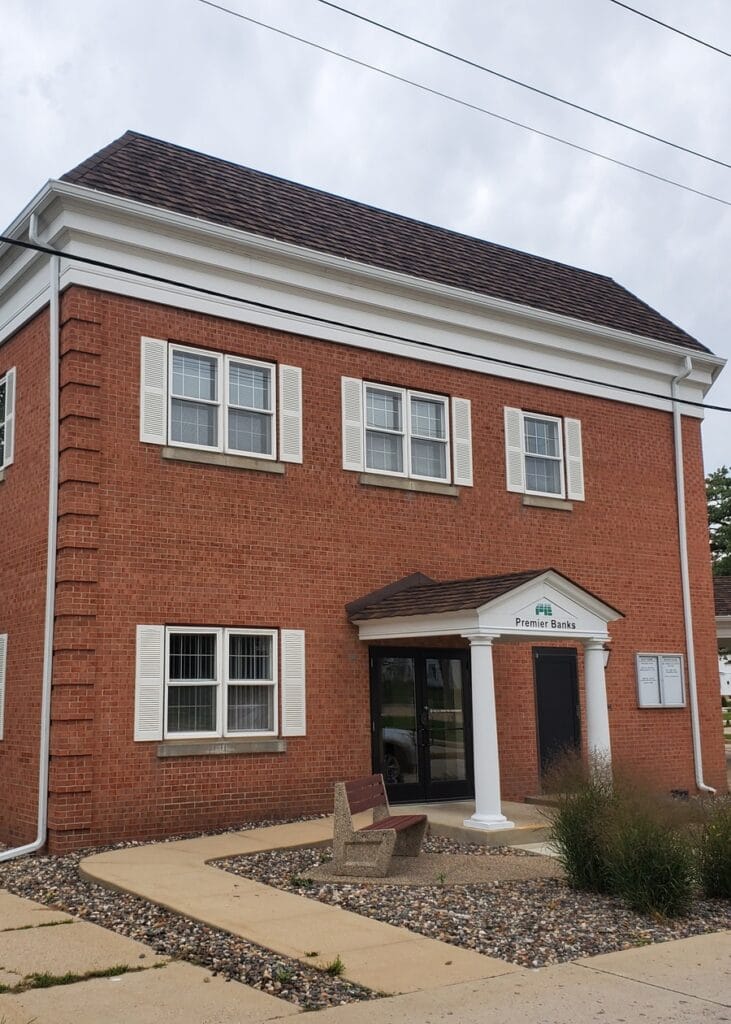 Commercial Gutter Project in Owatonna A professional seamless gutter system installed on the brick exterior of the Premier Banks building in Owatonna, MN.